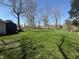 A large backyard with a lush lawn, mature trees, and ample space for outdoor activities at 4904 Betholm Dr, Indianapolis, IN 46239