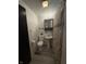 Bathroom featuring a small pedestal sink and shower with tile backsplash at 4904 Betholm Dr, Indianapolis, IN 46239