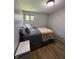 Bedroom featuring a queen bed, hardwood floors and a view of the outside at 4904 Betholm Dr, Indianapolis, IN 46239