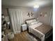 Relaxing bedroom with neutral tones, decorative wall hangings, and soft textures at 4904 Betholm Dr, Indianapolis, IN 46239