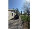 Side view of house with a driveway, fenced yard, and mature trees at 4904 Betholm Dr, Indianapolis, IN 46239