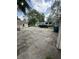 Wide exterior of home with large backyard and cracked parking area at 4904 Betholm Dr, Indianapolis, IN 46239
