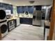 Well-lit kitchen features blue cabinets, stainless steel appliances, and butcher block countertops at 4904 Betholm Dr, Indianapolis, IN 46239