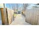 Exterior view of backyard with garage, wooden fences, and a concrete walkway at 4929 Kingsley Dr, Indianapolis, IN 46205