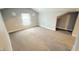 Cozy, bright carpeted bedroom with neutral paint, a window, and ample space at 4929 Kingsley Dr, Indianapolis, IN 46205