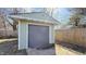 Close up of detached garage with gray door and a light green exterior at 4929 Kingsley Dr, Indianapolis, IN 46205