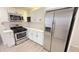 Modern kitchen with stainless steel appliances, white cabinets, and stylish countertops at 4929 Kingsley Dr, Indianapolis, IN 46205