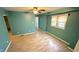 Cozy living room with hardwood floors, a ceiling fan, and bright windows, creating a welcoming atmosphere at 4929 Kingsley Dr, Indianapolis, IN 46205