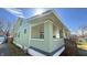 Stylish side porch perfect for relaxing, featuring brick and updated lighting at 4929 Kingsley Dr, Indianapolis, IN 46205