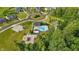 Community aerial view of neighborhood pool, play area, and roundabout near green trees and community homes at 5120 Melbourne Pl, Zionsville, IN 46077
