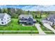 Aerial view highlighting a house with a beautiful front lawn with mature landscaping and a paved driveway at 5120 Melbourne Pl, Zionsville, IN 46077