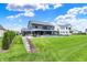 Backyard features a heated pool, hot tub, well-manicured lawn, and mature landscaping at 5120 Melbourne Pl, Zionsville, IN 46077