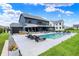 Inviting backyard pool area with modern lounge furniture, outdoor umbrella, hot tub, and lush lawn, perfect for relaxation at 5120 Melbourne Pl, Zionsville, IN 46077