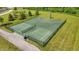 Aerial view of the basketball and volleyball court featuring lush greenery and fencing at 5120 Melbourne Pl, Zionsville, IN 46077