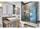 Modern bathroom featuring a glass-enclosed shower and vanity with marble countertop and stylish tiling at 5120 Melbourne Pl, Zionsville, IN 46077