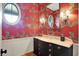Stylish powder room features unique zebra wallpaper, vanity with marble countertop, and decorative lighting at 5120 Melbourne Pl, Zionsville, IN 46077