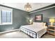 Well-lit bedroom features plush carpet, warm colors, large window and stylish furnishings at 5120 Melbourne Pl, Zionsville, IN 46077