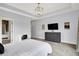 Spacious bedroom with a large dresser, desk, and decoratively lit tray ceiling for modern appeal at 5120 Melbourne Pl, Zionsville, IN 46077