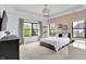 Well-lit bedroom with large windows, a comfortable bed, decorative chandelier, and stylish furnishings at 5120 Melbourne Pl, Zionsville, IN 46077