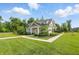 A charming clubhouse featuring lush landscaping and a welcoming walkway surrounded by a green lawn at 5120 Melbourne Pl, Zionsville, IN 46077