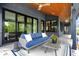Cozy covered patio featuring comfortable seating, stylish decor, and seamless indoor-outdoor living with sliding glass doors at 5120 Melbourne Pl, Zionsville, IN 46077