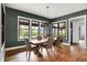 Dining room features hardwood floors, a rustic table, and a large window with backyard view at 5120 Melbourne Pl, Zionsville, IN 46077