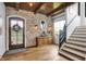Inviting entryway with wooden floors, brick accent wall, and natural light at 5120 Melbourne Pl, Zionsville, IN 46077