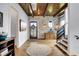 Charming entryway boasts wood floors, brick accent wall, and staircase with black railings at 5120 Melbourne Pl, Zionsville, IN 46077