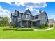 Stunning exterior of a gray home with manicured lawn, and inviting front porch at 5120 Melbourne Pl, Zionsville, IN 46077