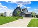 Gorgeous home exterior with a sprawling lawn, elegant landscaping, and a private driveway at 5120 Melbourne Pl, Zionsville, IN 46077