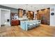 Spacious kitchen with a large island, hardwood floors, custom cabinets, and modern appliances at 5120 Melbourne Pl, Zionsville, IN 46077