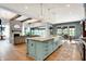 Gourmet kitchen featuring a large island, hardwood floors, farm sink, and access to the living room at 5120 Melbourne Pl, Zionsville, IN 46077
