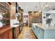 Modern kitchen featuring wood floors, custom cabinetry, a wine cooler, and sleek countertops at 5120 Melbourne Pl, Zionsville, IN 46077