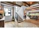 Open concept living room with hardwood floors, fireplace, staircase, and ample natural light at 5120 Melbourne Pl, Zionsville, IN 46077