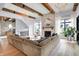 Bright living room boasts a brick fireplace, wood beams, chandelier, and an oversized sofa at 5120 Melbourne Pl, Zionsville, IN 46077