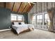 Bright main bedroom featuring a vaulted ceiling, fan, and two windows overlooking the neighborhood at 5120 Melbourne Pl, Zionsville, IN 46077