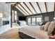 Bright main bedroom suite with fireplace, sliding glass door leading to deck, and wood beam ceiling at 5120 Melbourne Pl, Zionsville, IN 46077