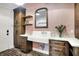 Well-designed mud room with custom cabinets, sink, brick floors, and stylish accents at 5120 Melbourne Pl, Zionsville, IN 46077
