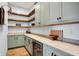 Walk-in pantry features custom shelving, countertops, and a wine refrigerator for storage at 5120 Melbourne Pl, Zionsville, IN 46077
