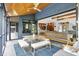 Inviting patio with a dining table and seamless transition to the indoor living space with vaulted ceilings at 5120 Melbourne Pl, Zionsville, IN 46077