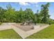 Exterior view of a community playground area with a playground, shaded seating, and trash receptacle at 5120 Melbourne Pl, Zionsville, IN 46077