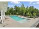 Gorgeous pool area with chairs and nearby trees, perfect for relaxation and recreation at 5120 Melbourne Pl, Zionsville, IN 46077