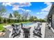 Outdoor living area features a beautiful in-ground pool, umbrella, and an outdoor seating area at 5120 Melbourne Pl, Zionsville, IN 46077