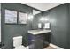 Stylish powder room with dark vanity, marble countertop, and decorative wall art at 5120 Melbourne Pl, Zionsville, IN 46077