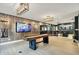 Finished basement with shuffleboard, tv, and bar area; great for entertaining at 5120 Melbourne Pl, Zionsville, IN 46077