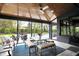 Screened-in sunroom offers backyard views and features an outdoor dining area and ceiling fan at 5120 Melbourne Pl, Zionsville, IN 46077