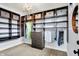 Spacious walk-in closet with custom shelving, hanging rods, drawers, and modern lighting at 5120 Melbourne Pl, Zionsville, IN 46077