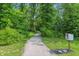 Scenic walking path in the community with lush greenery and a little free library on the side at 5120 Melbourne Pl, Zionsville, IN 46077