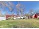 A spacious backyard featuring multiple sheds, a hot tub, and a trampoline under a bright blue sky at 5330 Manker St, Indianapolis, IN 46227