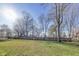 Expansive green backyard surrounded by mature trees and a classic wooden fence at 5330 Manker St, Indianapolis, IN 46227